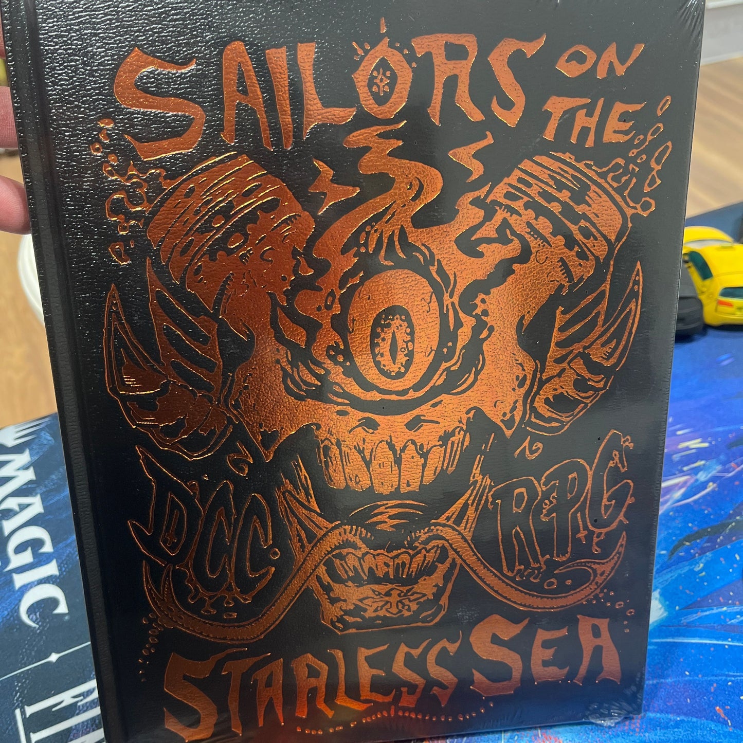 DCC Sailors on the Starless Sea Foil Edition RPG book by Goodman Games, featuring cover art with sailors and a starless sea scene
