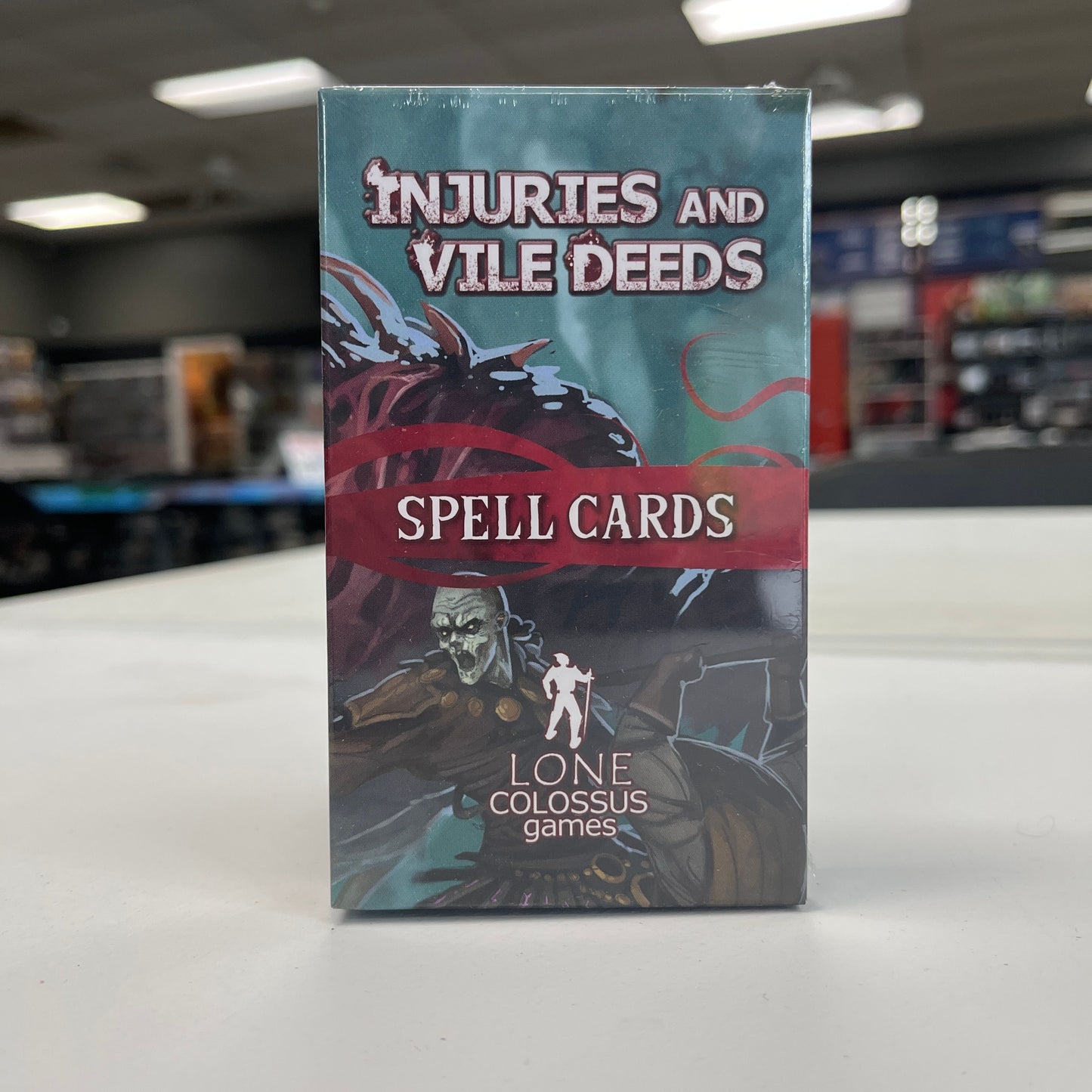 Injuries and Vile Deeds Spell cards from TCB Games & Collectibles, featuring detailed artwork on collectible fantasy spell cards.