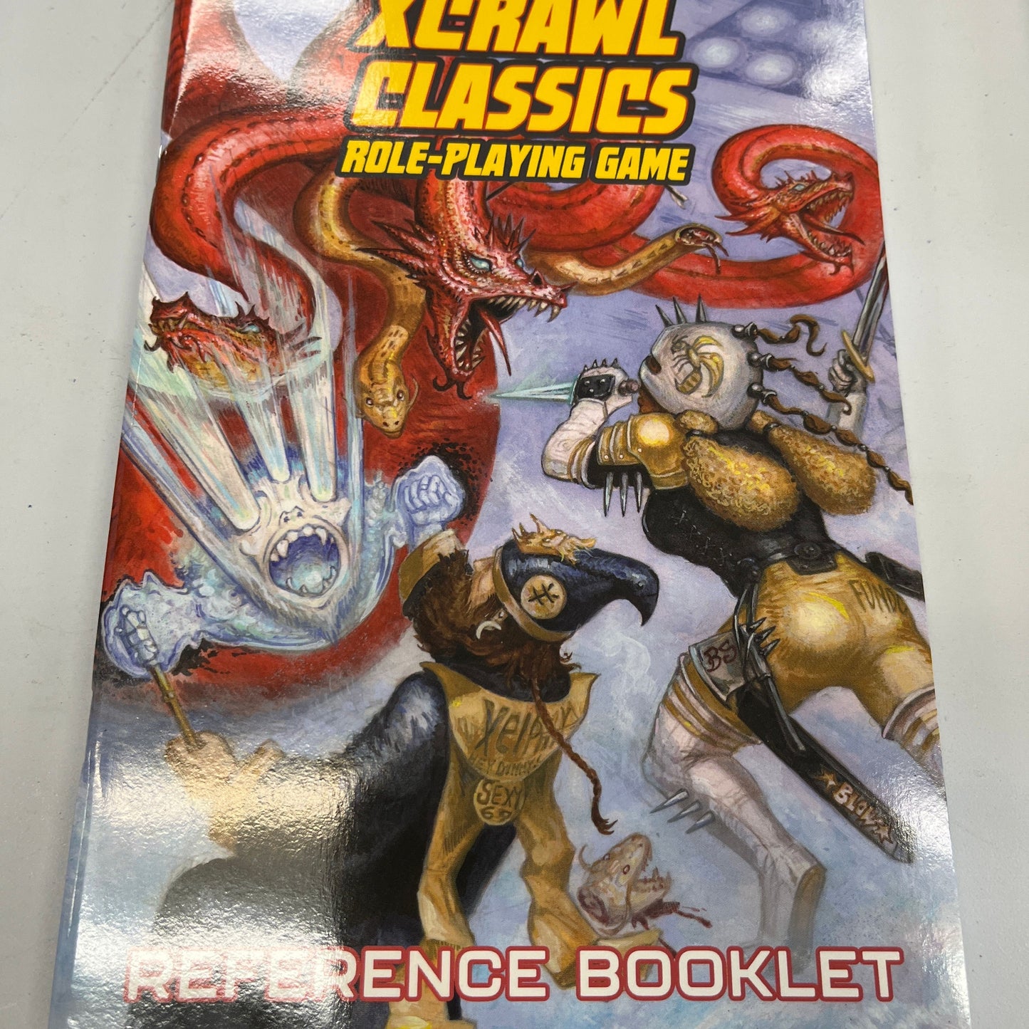Xcrawl Classics RPG Reference Booklet by TCB Games & Collectibles, featuring detailed tables and character information.